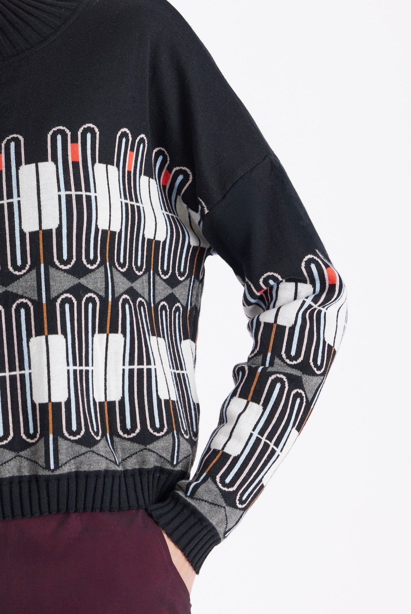 Pullover KIRBO mit Rundhals, langen Armen und geometrischem Muster in Schwarz, Weiß und Orange